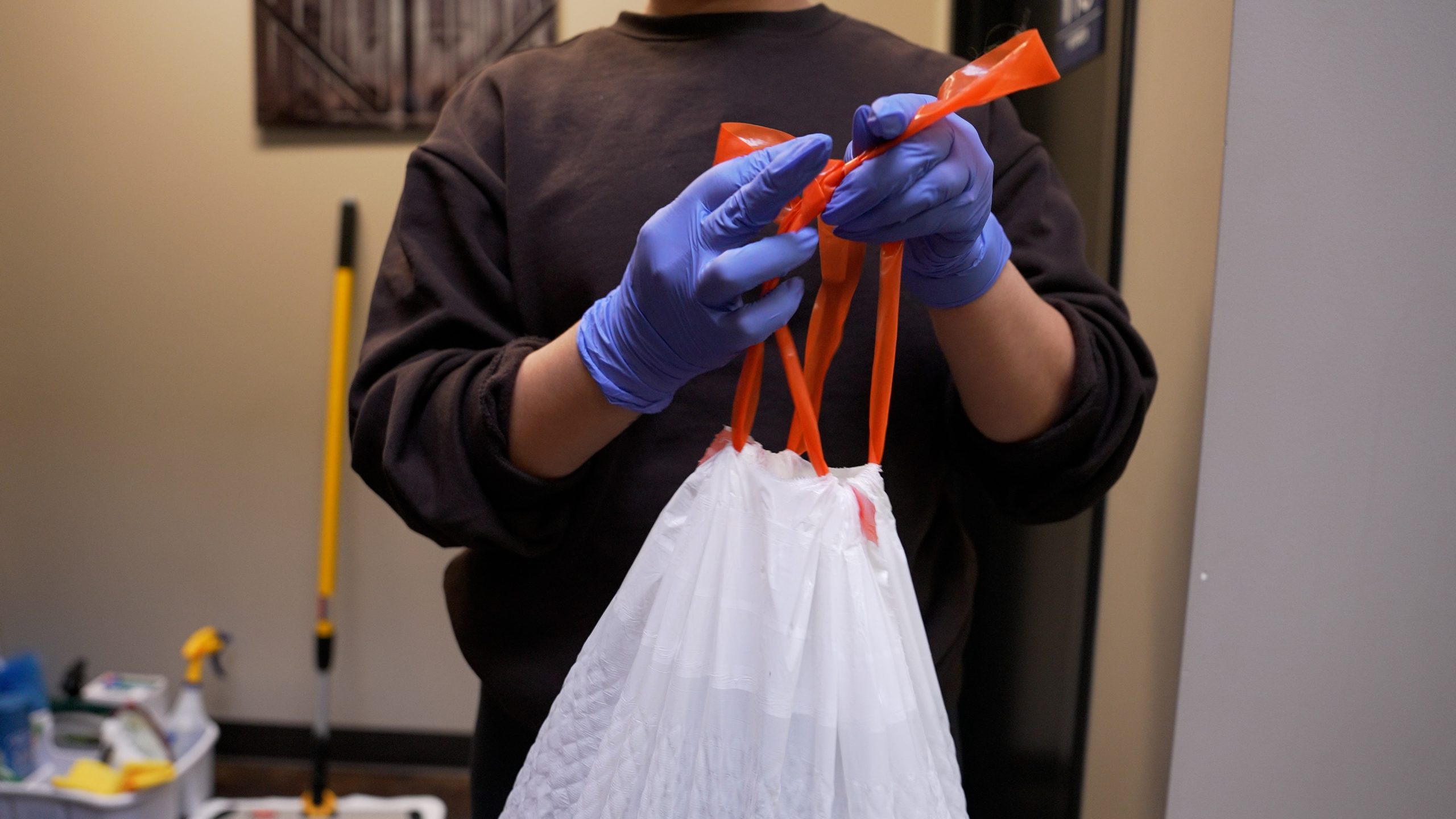 industrial cleaning services - cleaner dumping the trash 